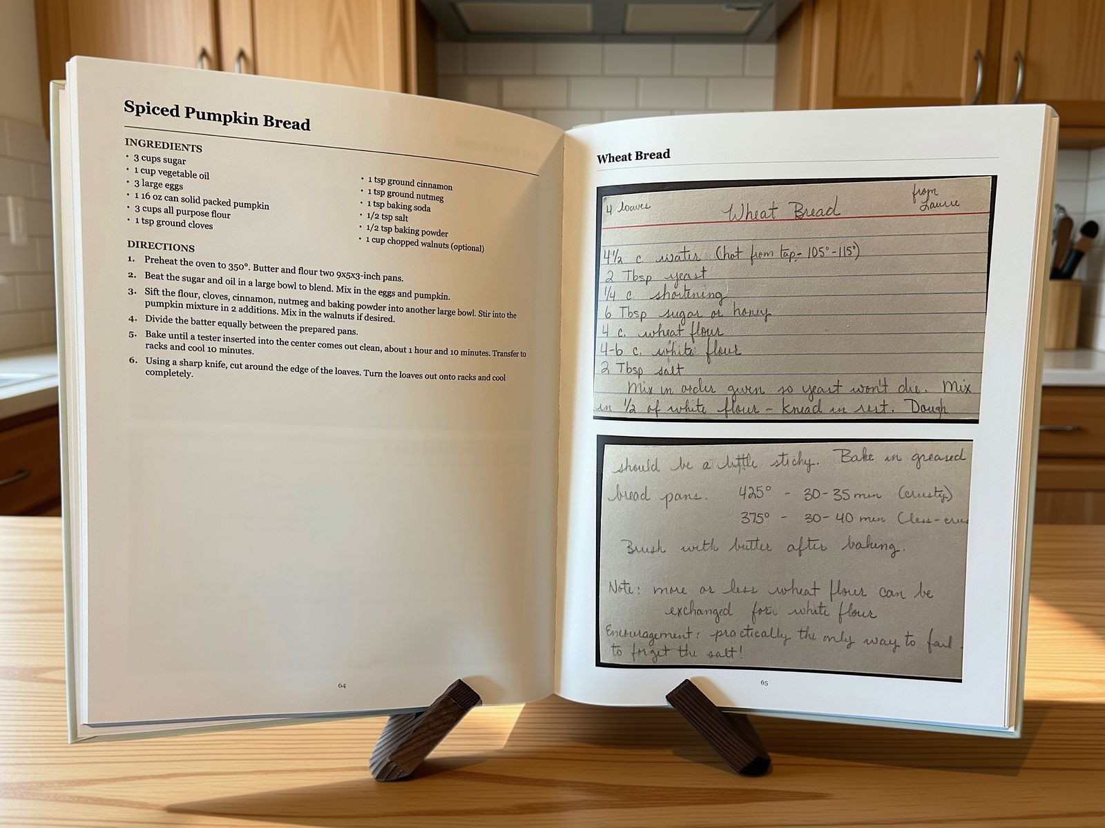 A finished Butter & Ink hardcover recipe book open on a kitchen counter, a typeset recipe on the left page and a handwritten recipe card preserved as a scan on the right